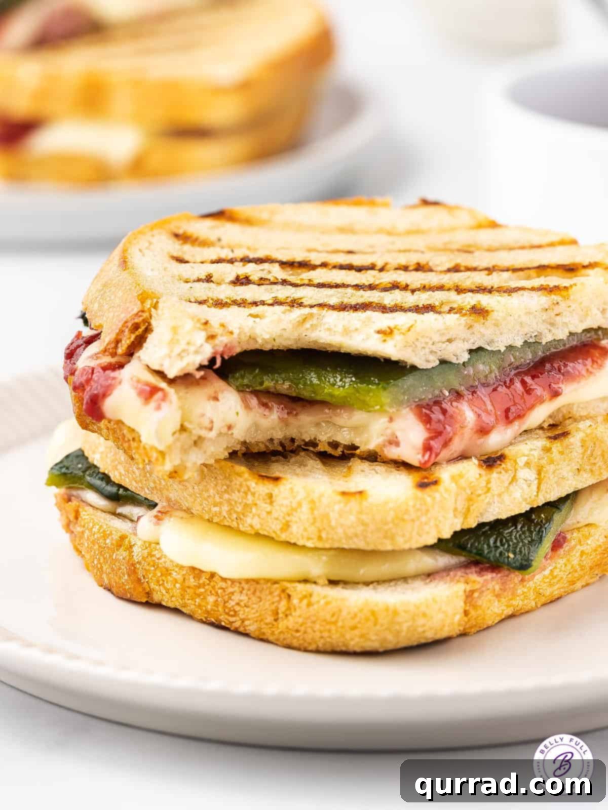 stacked sandwich with melted brie and roasted poblano peppers