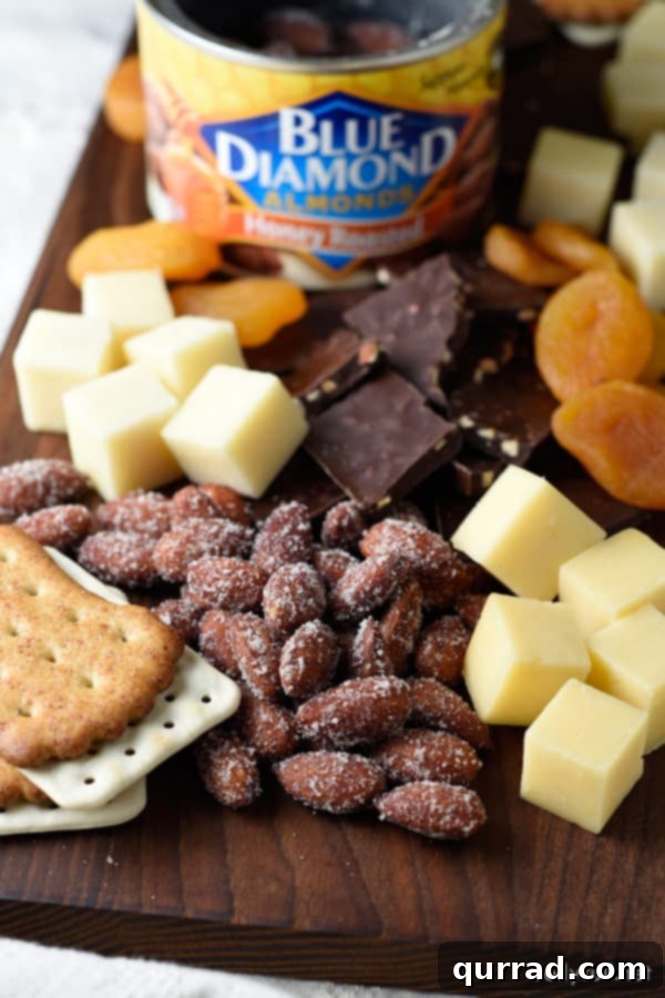 Showcasing Blue Diamond Nuts with Cheese and Crackers on a Board in 15 Minutes! A close-up view of Blue Diamond almonds alongside cubed cheese and various crackers, highlighting the quality of the ingredients.