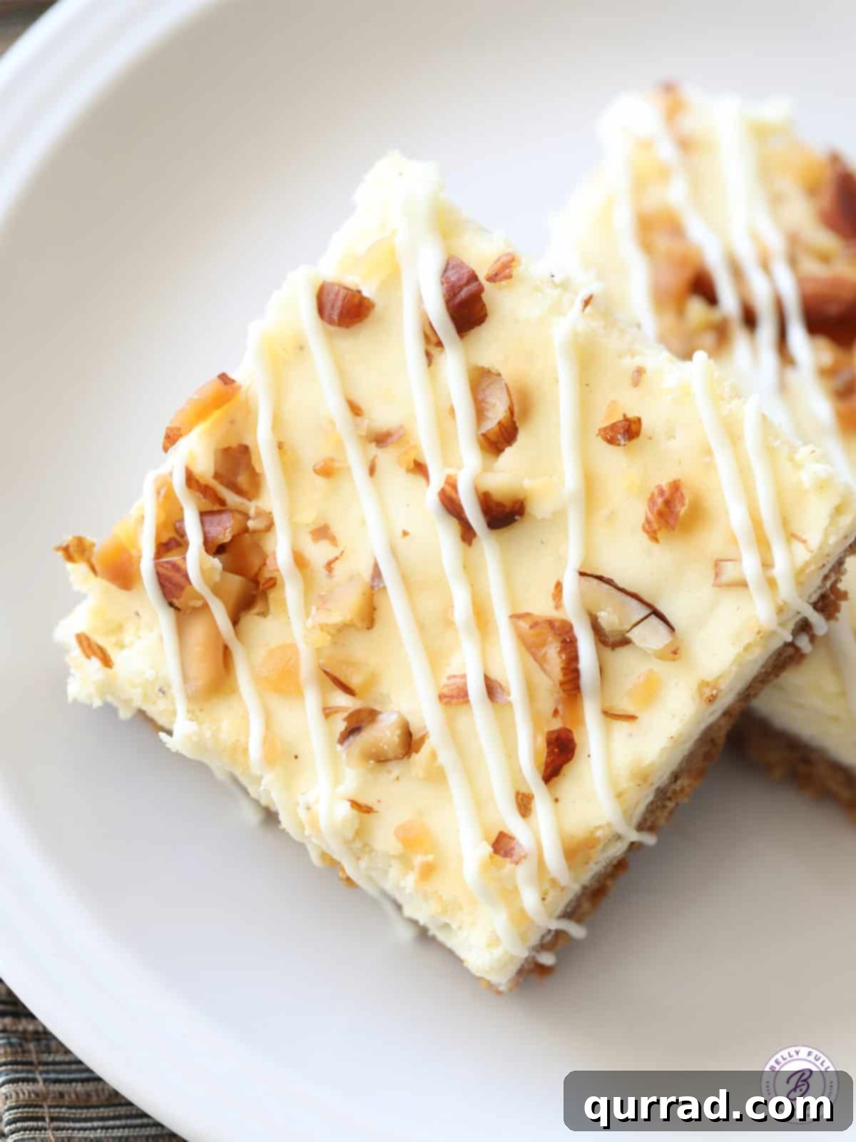 Spiced Eggnog Cheesecake Squares 3 close up cheesecake bar with white chocolate drizzle