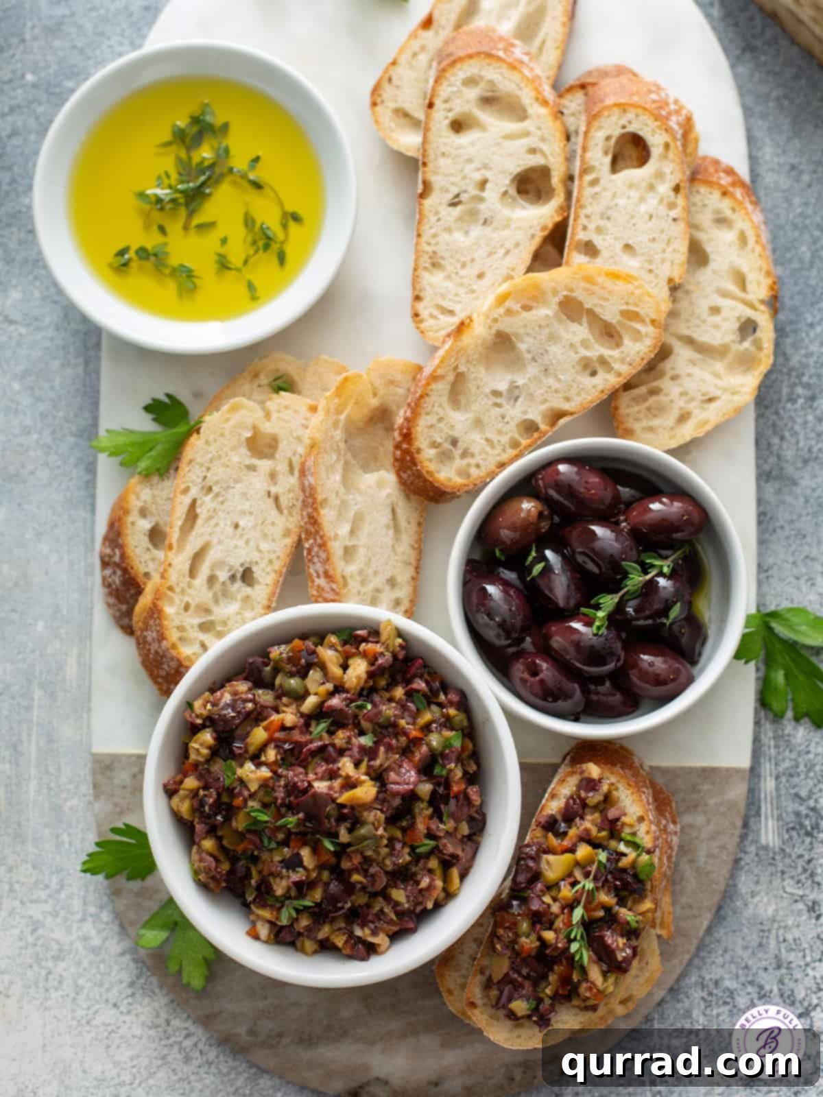 Savory Olive Spread 3 bowl of olives and freshly made tapenade with crostini on a wooden board