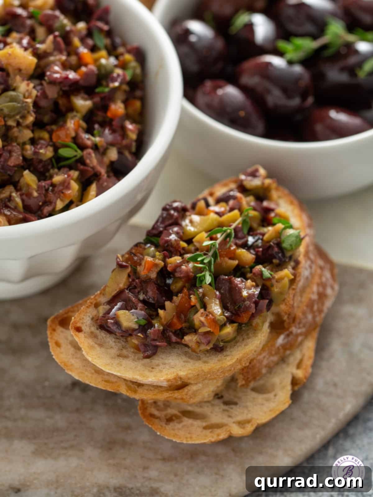 Savory Olive Spread 5 close-up of chopped olive tapenade on crostini, ready to serve