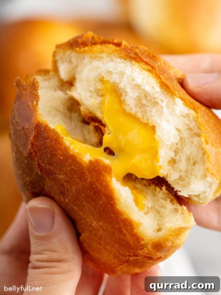 Cheesy Ghoul Rolls 2 Close up image of a cheese zombie being split in half, revealing the warm, melted cheese inside.