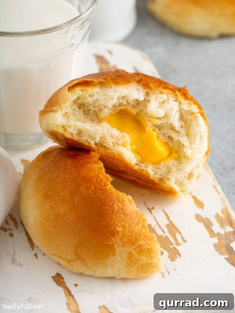 Cheesy Ghoul Rolls 9 A baked cheese zombie split open, revealing the luscious, golden, melted Velveeta cheese center.