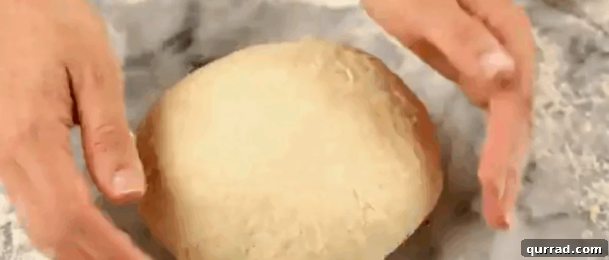 Cheesy Ghoul Rolls 6 Hands kneading the bread dough on a lightly floured surface until smooth and elastic.