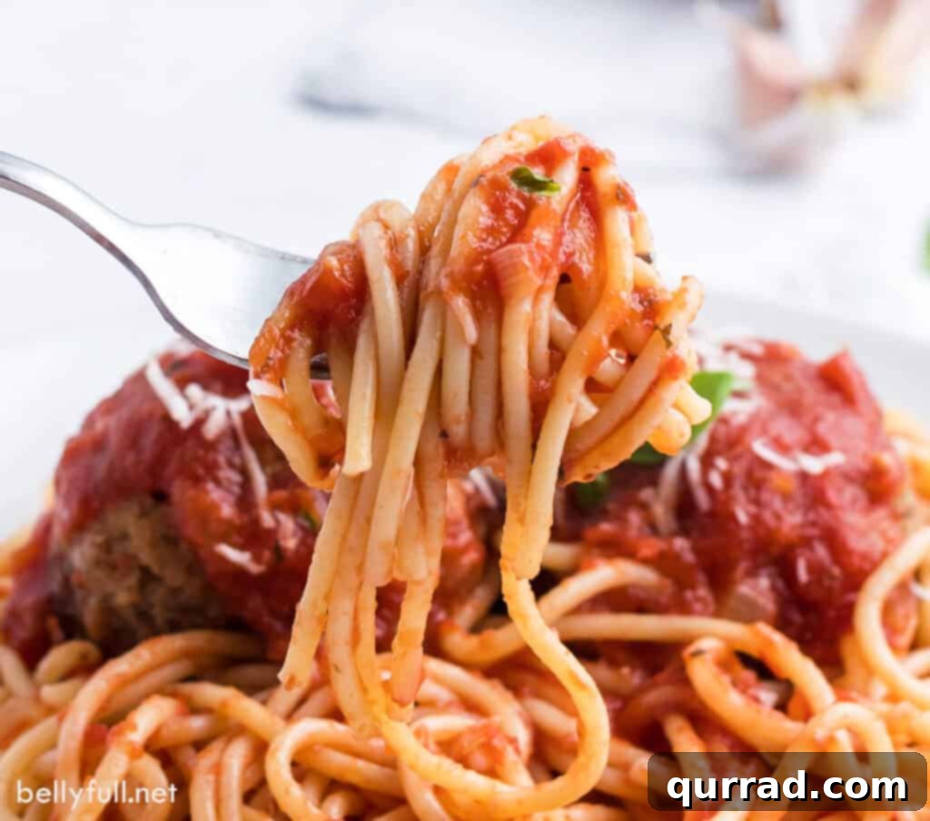 Slow-Simmered Marinara Sauce 5 close up of spaghetti with rich marinara sauce clinging to a fork, ready for a bite