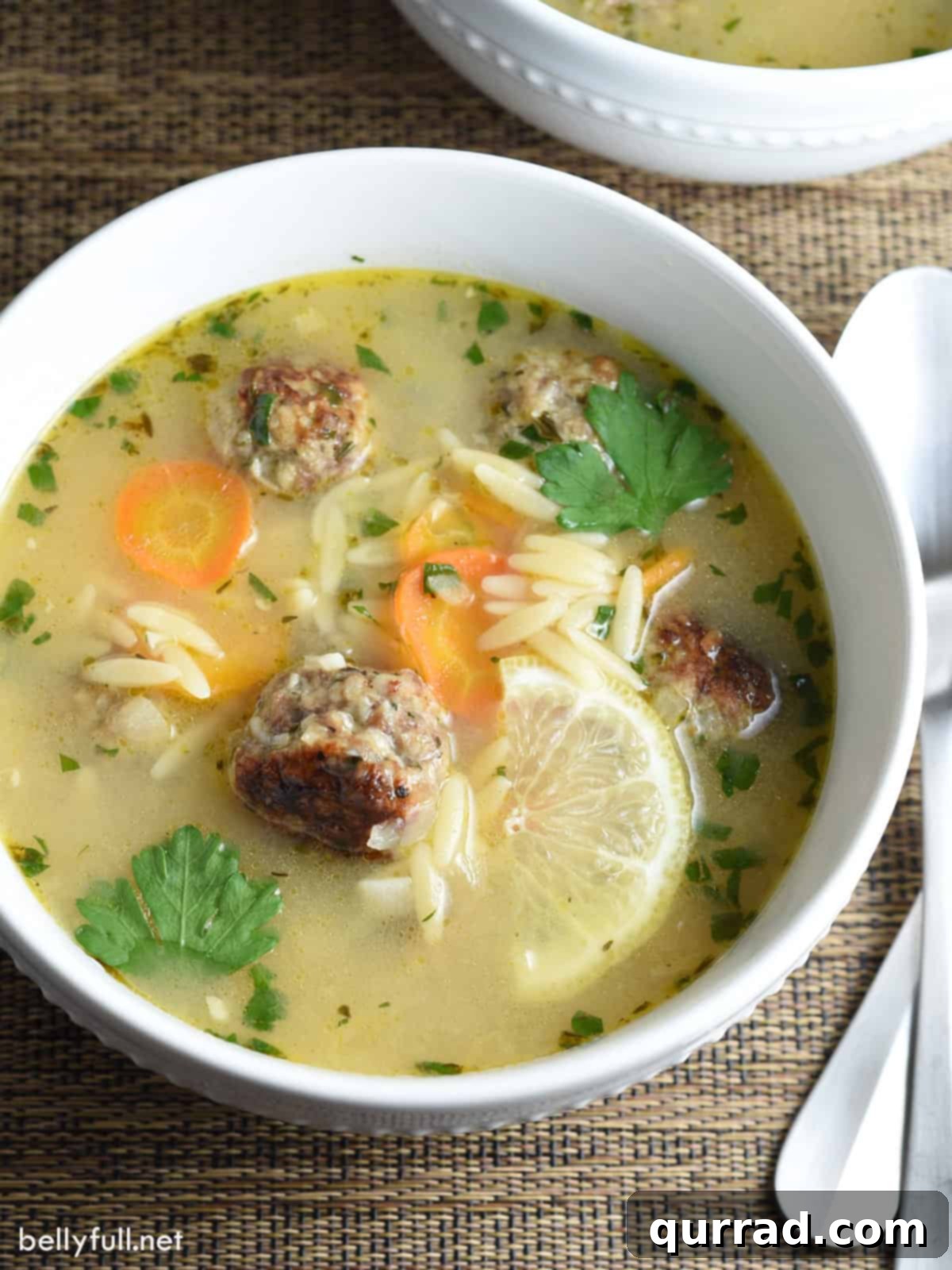 Hearty Meatball Soup 2 overhead bowl of meatball soup with orzo and lemon slice