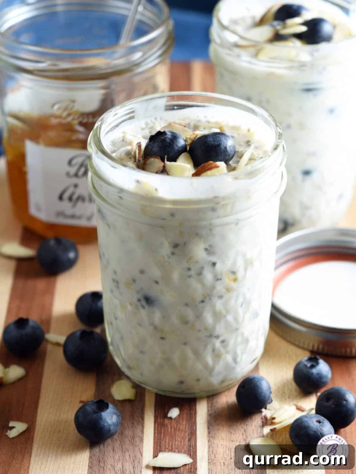 A glass jar filled with overnight oats, topped with fresh blueberries, ready for a quick and healthy breakfast.