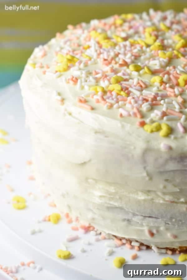 Surprise Inside Piñata Cake 3 A whole Piñata Cake beautifully frosted with pastel sprinkles, standing proudly on a serving dish, hinting at the sweet surprise within.