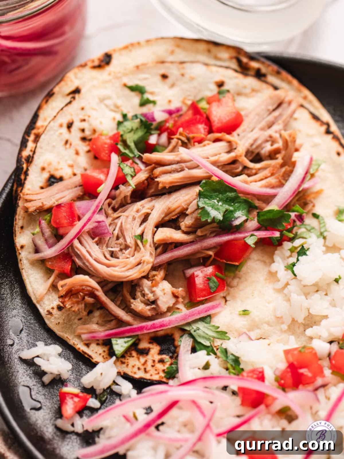 Shredded Cuban pork over rice and tortillas with pico de gallo, a full spread.