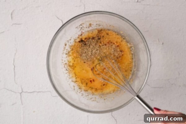 Mojo sauce ingredients being whisked in a mixing bowl.