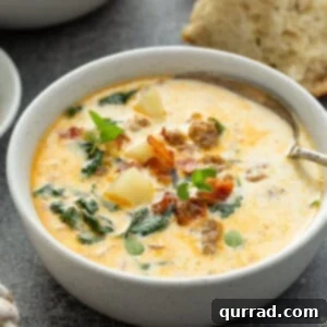 Side view of a bowl of homemade Zuppa Toscana soup, showing its rich texture and ingredients.