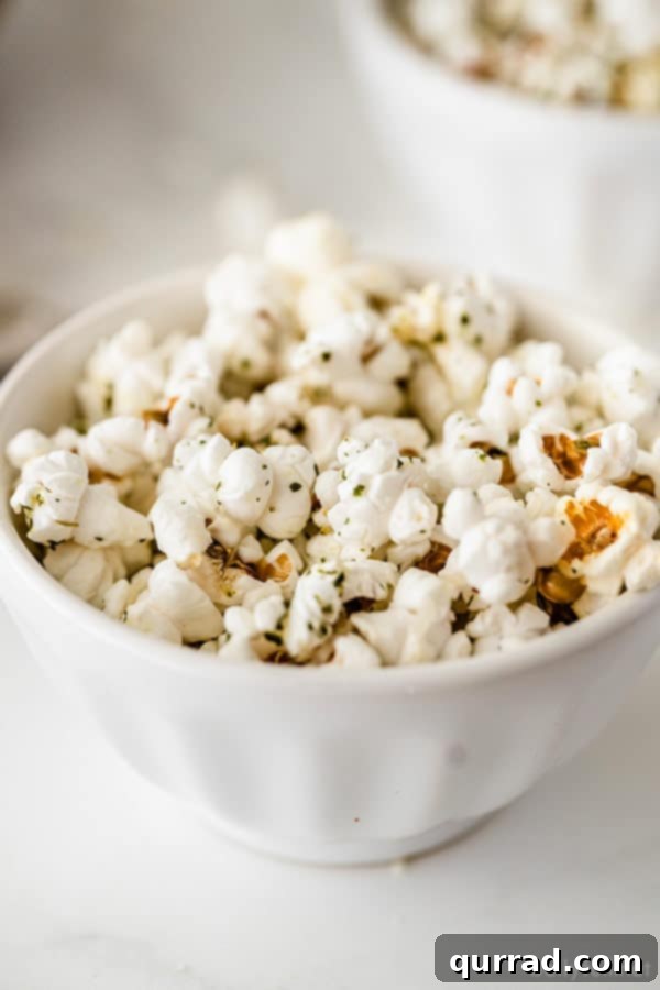 Close-up of Seasoned Garlic Bread Popcorn portion of garlic bread flavored popcorn in white dish