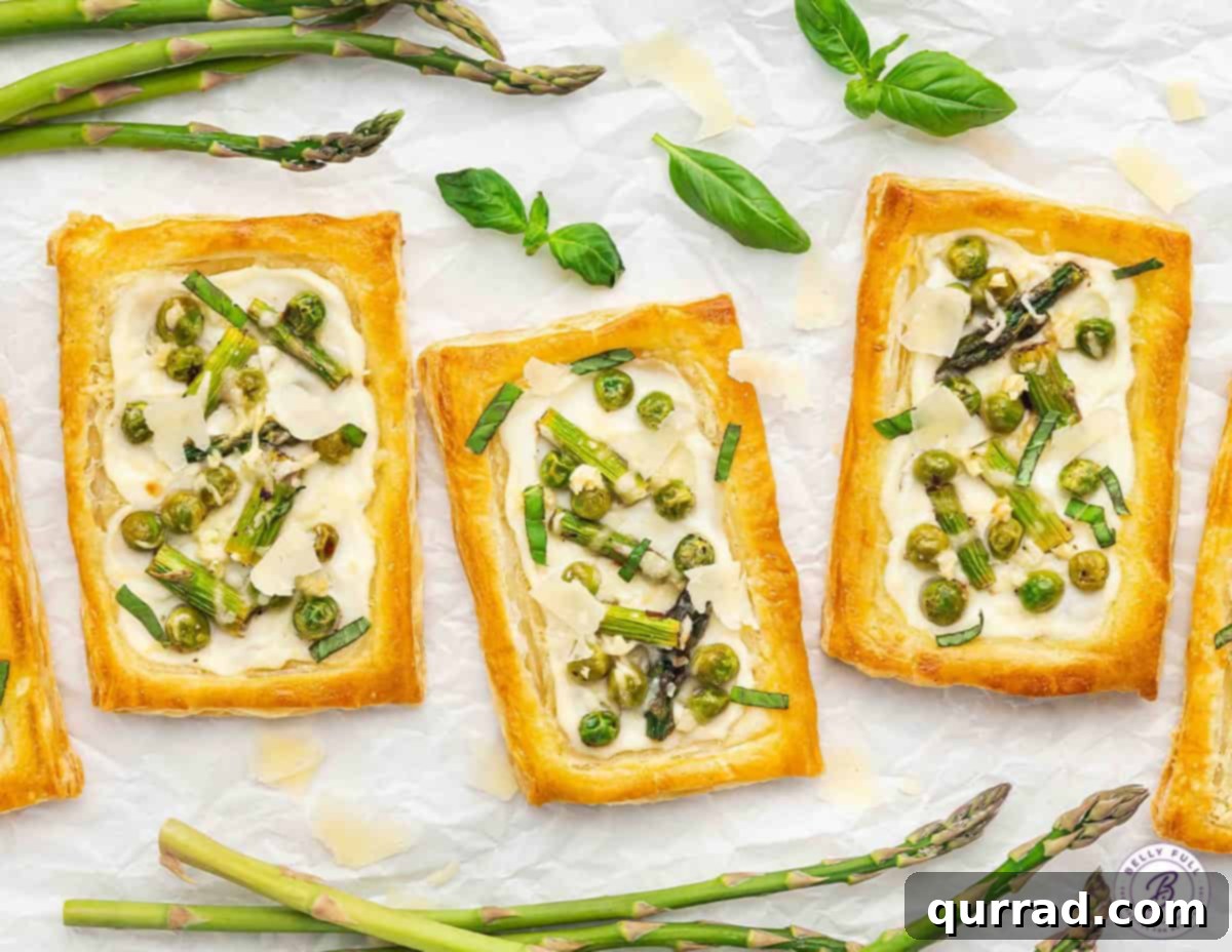 Springtime Asparagus Gems 12 Three baked golden Asparagus Puff Pastry Tarts arranged on parchment paper, showcasing their perfect bake.