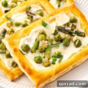 Springtime Asparagus Gems 3 Close up baked golden Asparagus Puff Pastry Tarts on plate