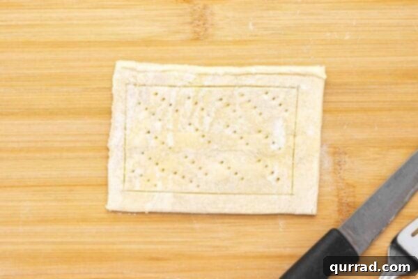 Springtime Asparagus Gems 5 Unbaked puff pastry rectangle with scored border and poked center with fork tines.