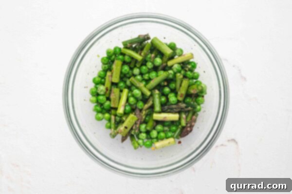 Springtime Asparagus Gems 8 Baby peas, asparagus pieces, and seasonings mixed in a bowl.