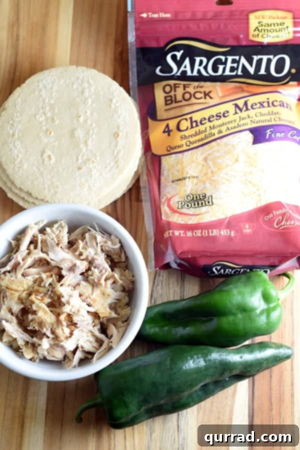 Crispy Chicken and Cheese Taquitos 3 Ingredients for baked chicken and cheese taquitos including shredded chicken, poblano pepper, cheese, and tortillas.