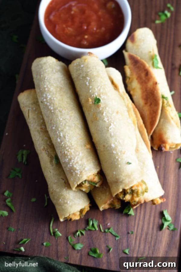 Crispy Chicken and Cheese Taquitos 4 Close-up of baked chicken and cheese taquitos with a golden, crispy shell.