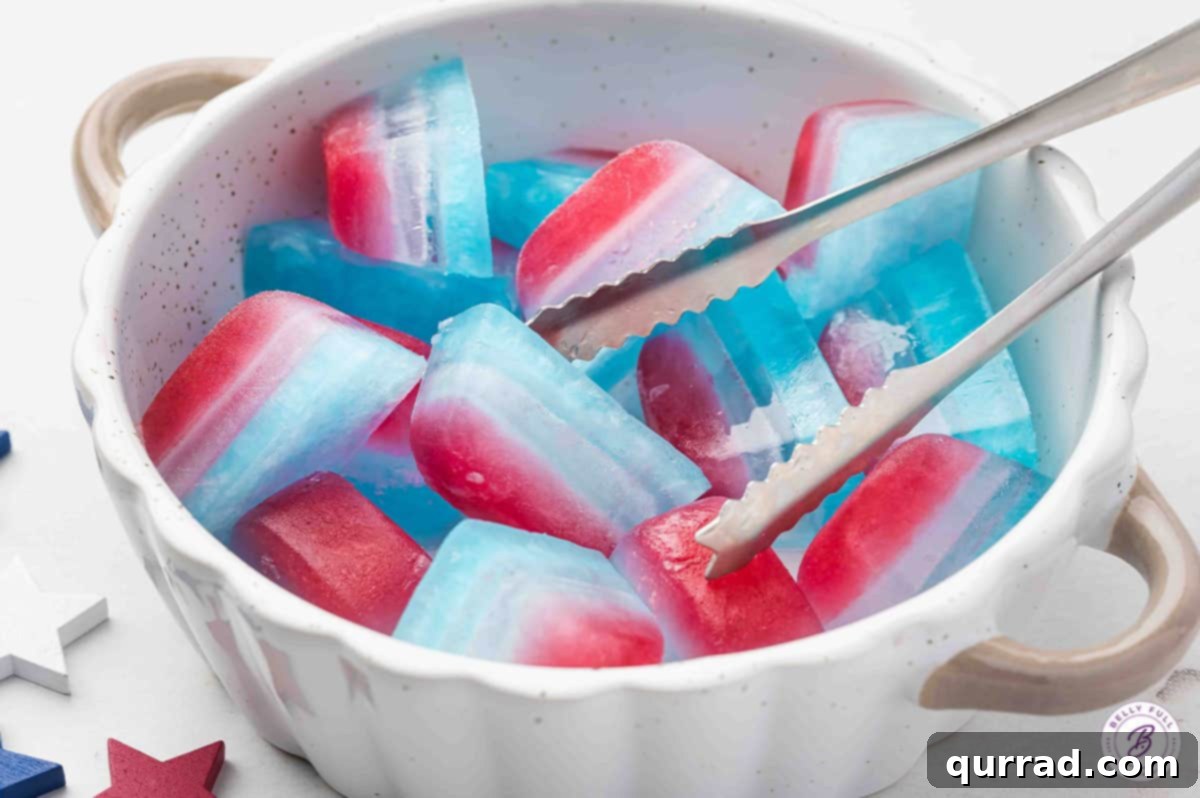 Stars and Stripes Chillers 8 A bowl filled with layered red, white, and blue ice cubes, with serving tongs.