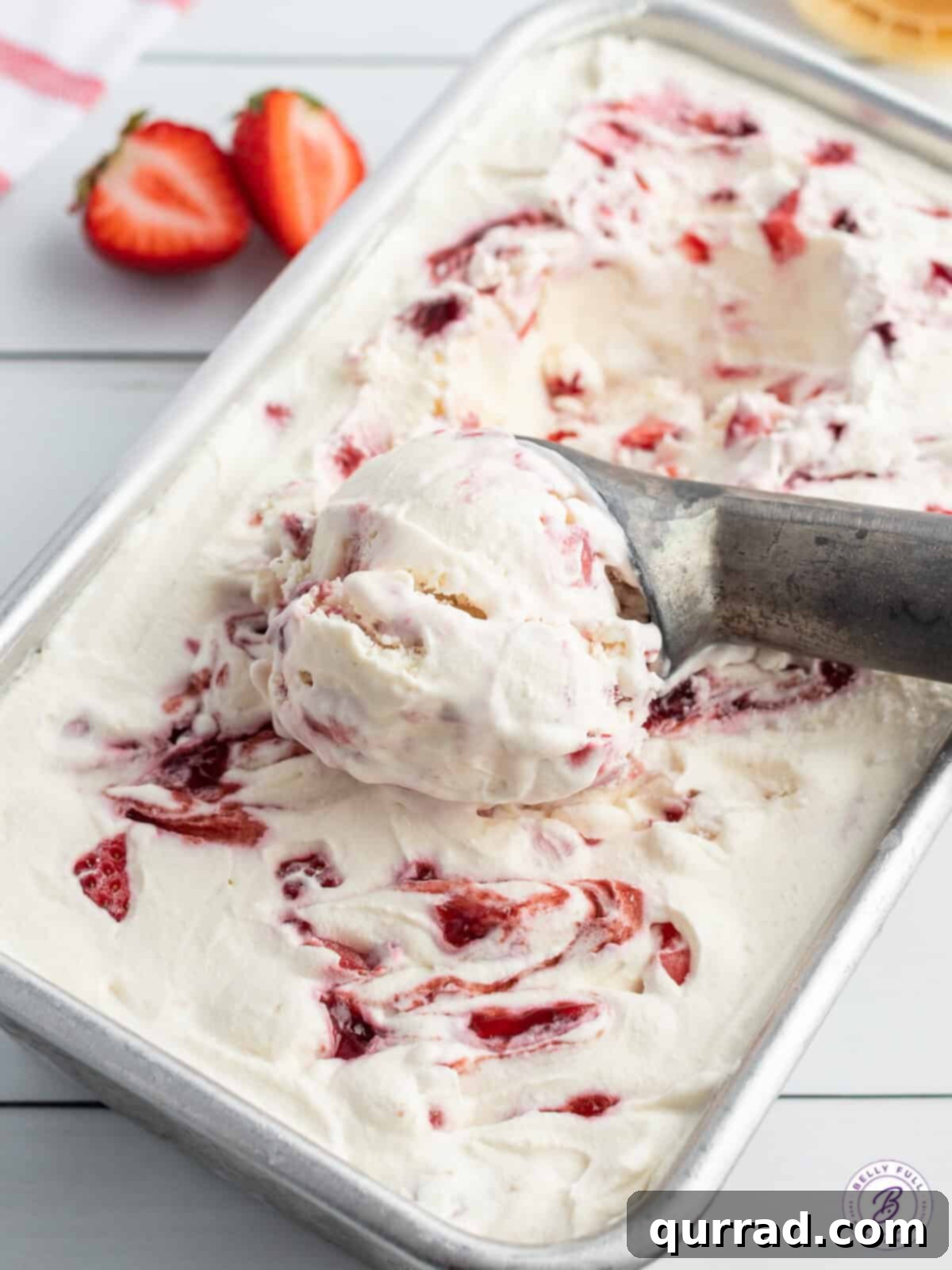 Creamy No-Churn Strawberry Delight 2 A perfectly rolled scoop of creamy strawberry ice cream, showcasing its rich texture and natural color.