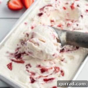 Creamy No-Churn Strawberry Delight 3 Close-up of strawberry ice cream swirl in a loaf pan
