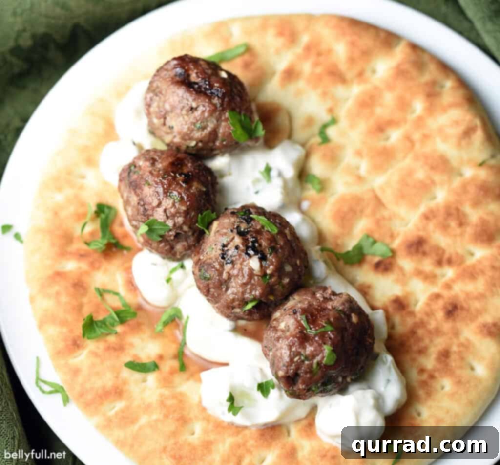 Spiced Beef Kofta Meatballs 4 4 meatballs on top of yogurt sauce and naan bread