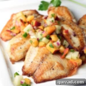 Pan Seared Tilapia filets are topped with a fresh, bright, and simple peach and cucumber salsa. Delicious 30 minute meal!