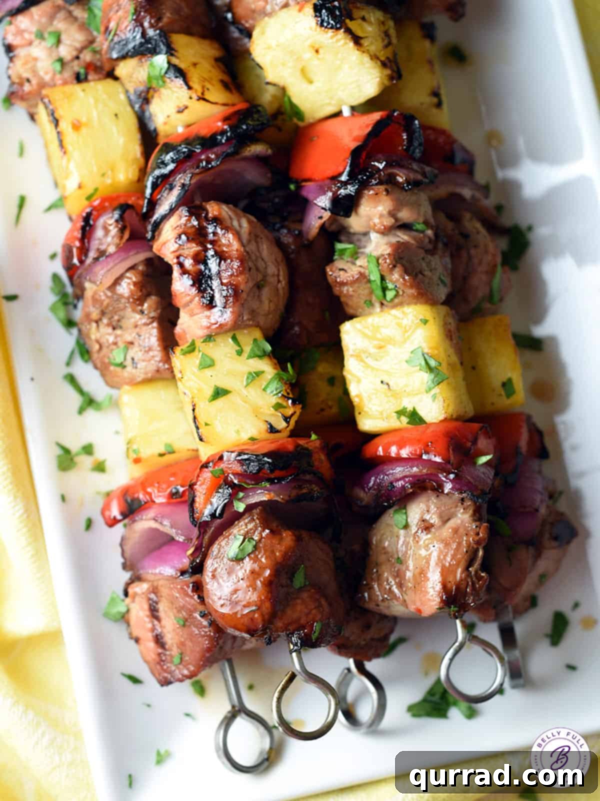 Flame-Kissed Teriyaki Pork Skewers 2 overhead stack of grilled teriyaki pork kabobs on serving tray