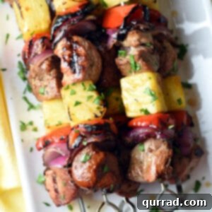 overhead stack of grilled teriyaki pork kabobs on serving tray