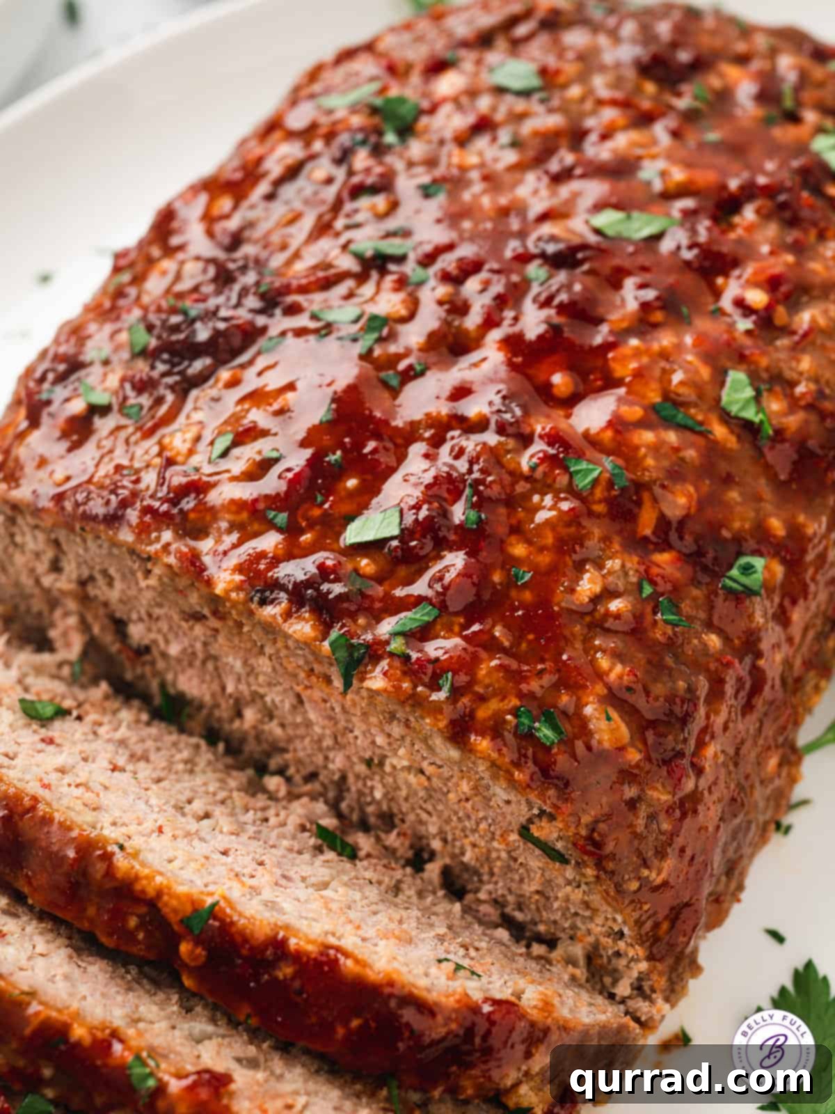 Whole loaf of Honey Chipotle Glazed Meatloaf, glistening with its sweet and spicy topping.