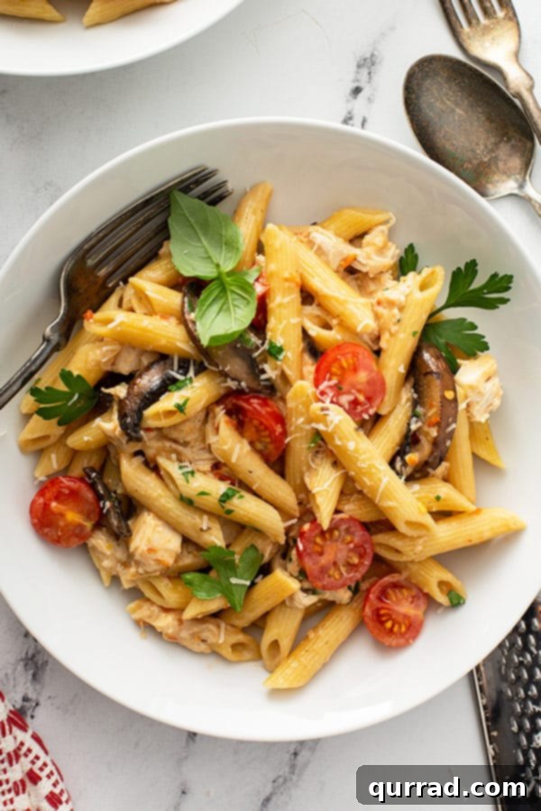 overhead of Tuscan Chicken Pasta in white bowl, beautifully plated and ready to eat