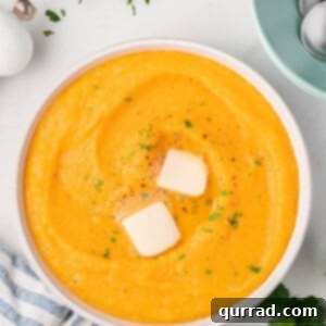 overhead bowl of butternut squash mashed potatoes with 2 pats of butter