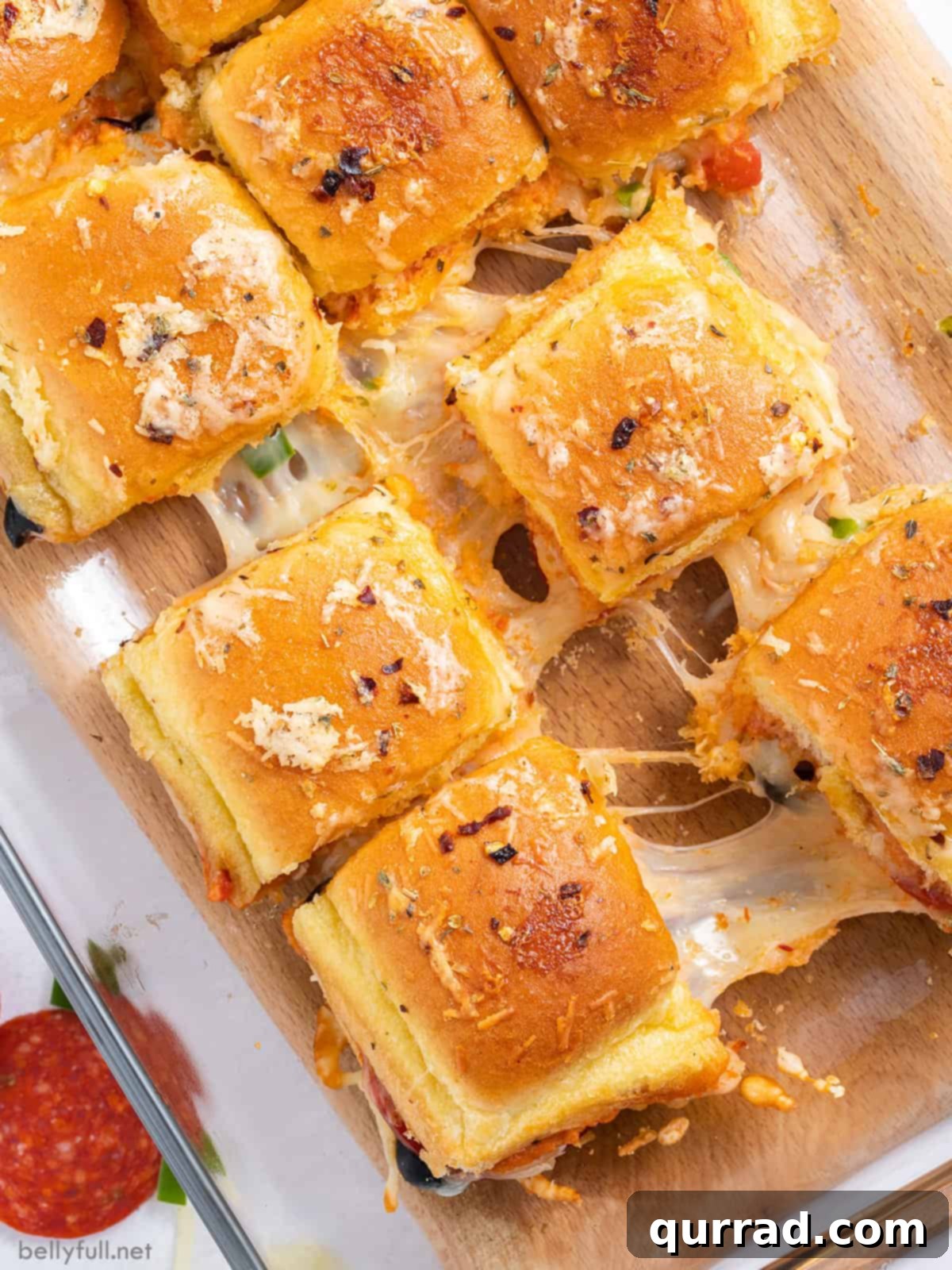 Supreme Pizza Pull-Aparts 2 Overhead shot of cheesy Pizza Supreme Sliders, pulled apart to reveal melted cheese and vibrant toppings