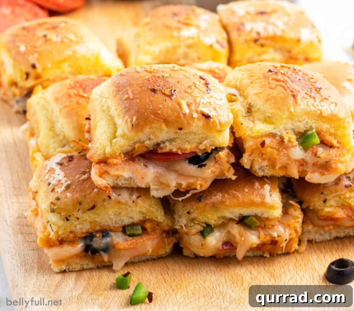 Supreme Pizza Pull-Aparts 5 A stack of perfectly cut Pizza Supreme Sliders on a wooden cutting board, ready to serve