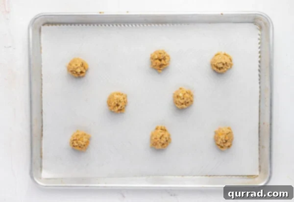 Layers of Cookie Joy 11 butterscotch oatmeal cookie dough on a parchment lined baking sheet