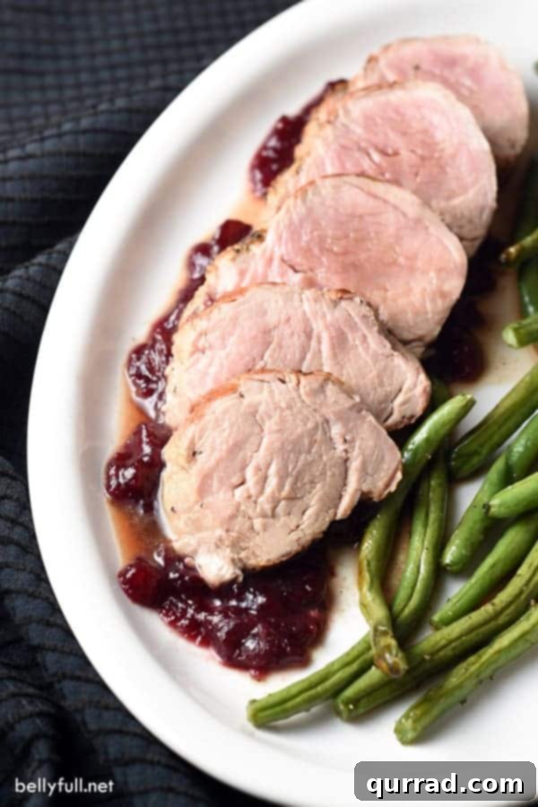 Pork Tenderloin with Roasted Garlic and Cracked Black Pepper 3 Perfectly cooked pork tenderloin slices with a rich cranberry-pomegranate glaze, accompanied by crisp roasted green beans.