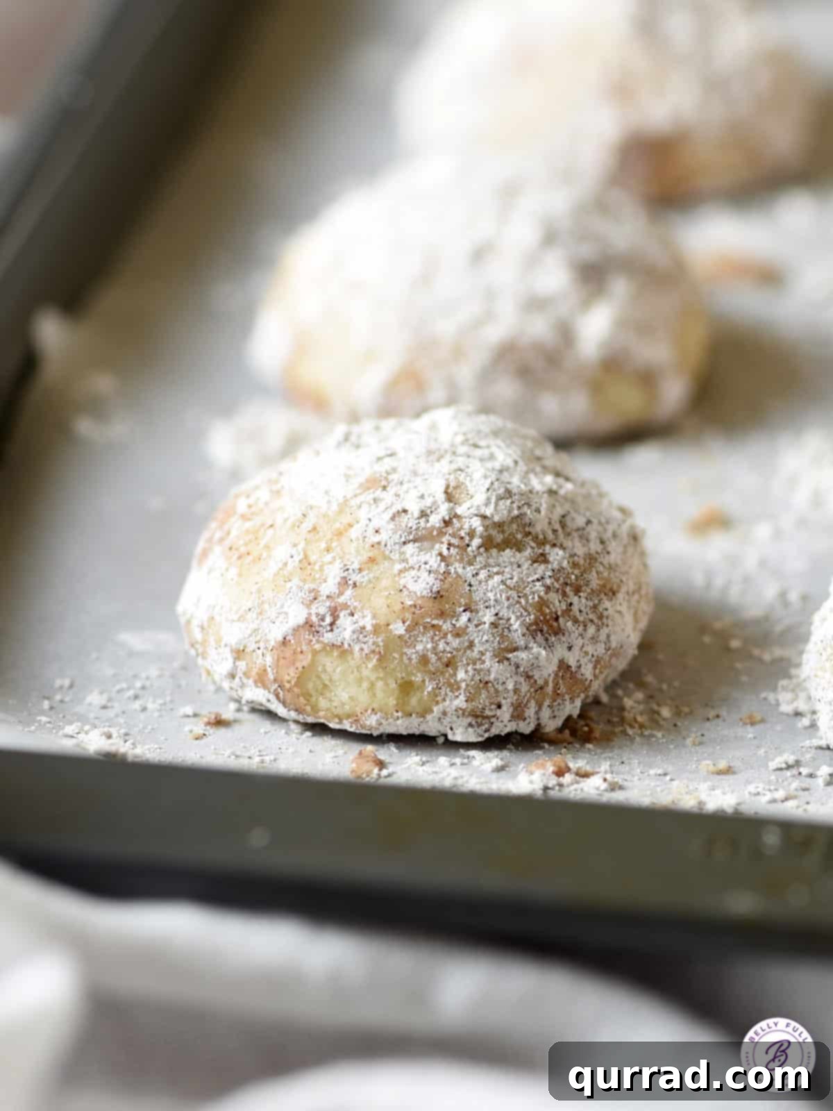 Cozy Chai Snowballs 2 snowdrop cookies on baking sheet