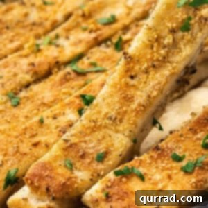 Effortless Skillet Breadsticks 6 Close-up of golden baked cheesy breadsticks, generously sprinkled with Parmesan, showcasing a crispy exterior.