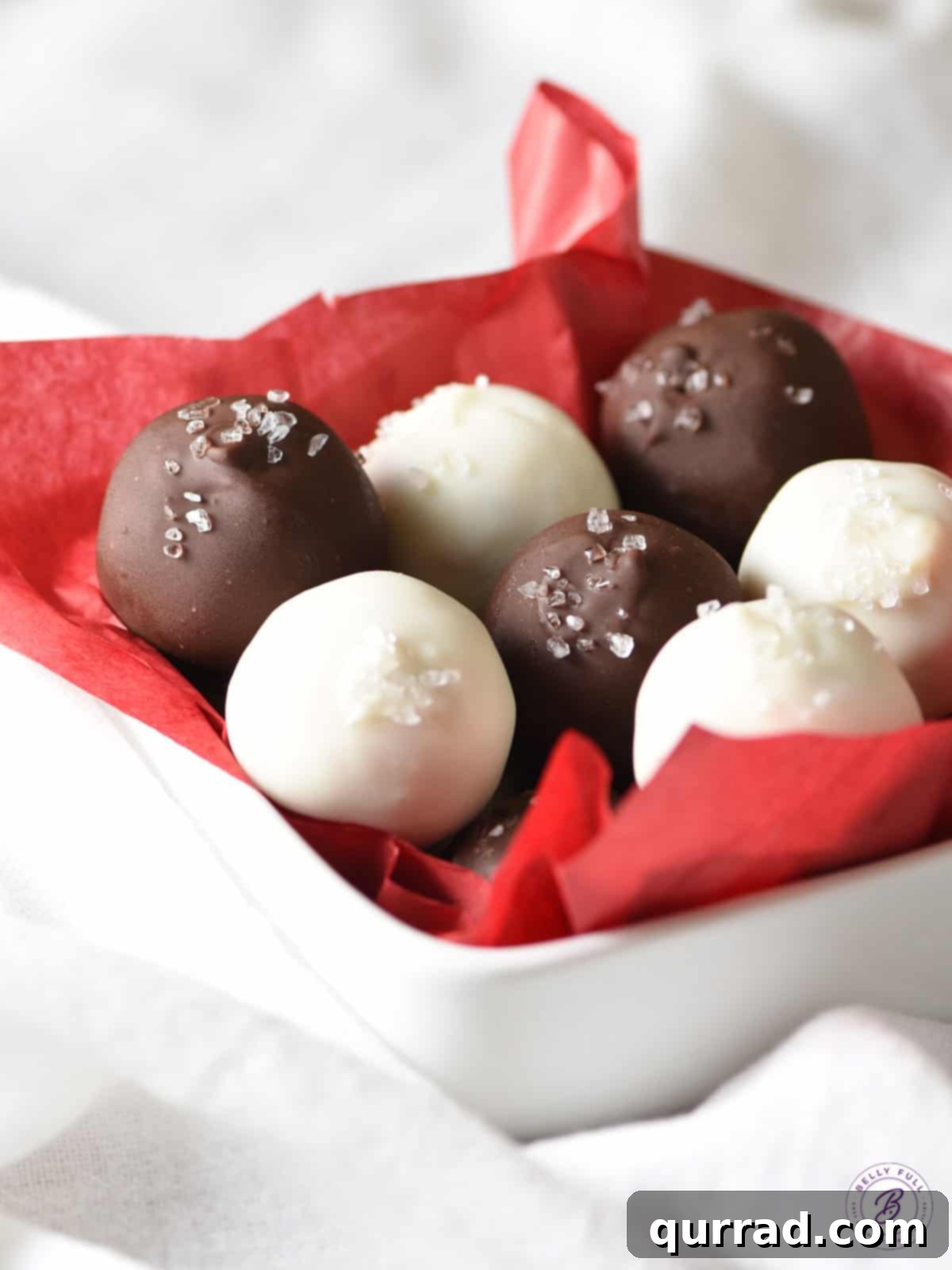 Holiday Eggnog Truffles 2 bowl of white and dark chocolate truffles in red tissue paper