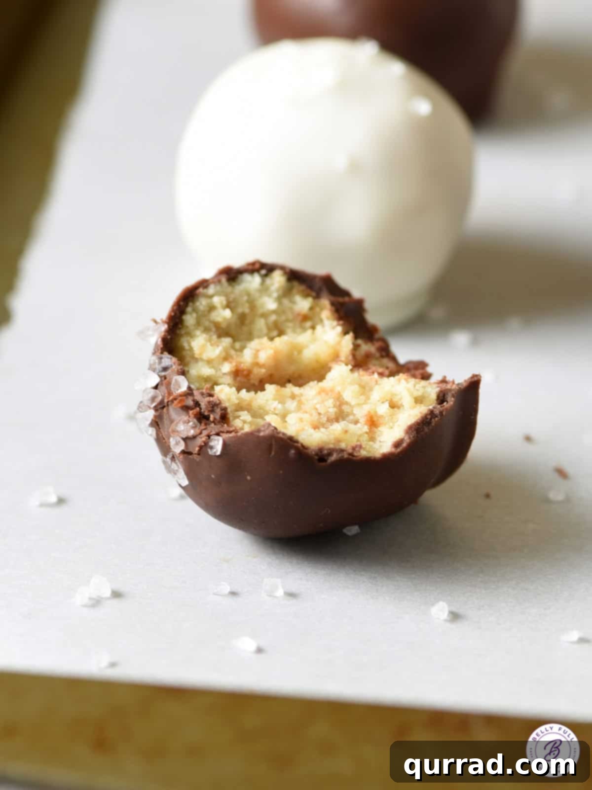 Holiday Eggnog Truffles 4 chocolate coated eggnog cake ball with bite taken