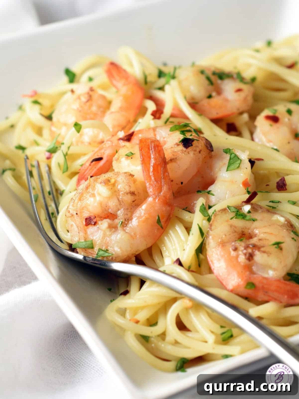 Citrus-Infused Balsamic Shrimp Pasta 3 cooked shrimp with tail on over a bed of spaghetti