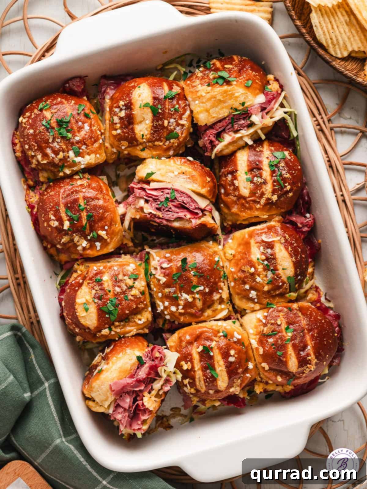 Irresistible Pretzel Reuben Sliders 2 overhead casserole dish full of Reuben Pretzel Sliders, showing golden-baked pretzel buns