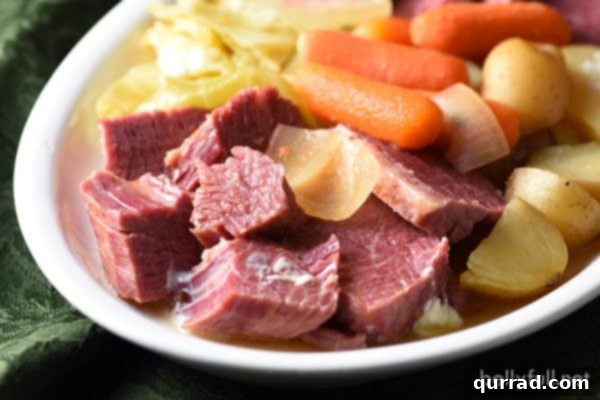 Thai Twist on Corned Beef and Cabbage 2 Close-up of Slow Cooker Corned Beef and Cabbage in a crockpot, showing tender beef and vibrant vegetables cooking.
