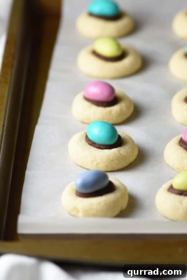 Effortless Easter and Spring Delights 7 Light and flaky thumbprint cookies with a rich chocolate ganache center, topped with a colorful M&M egg for Easter.