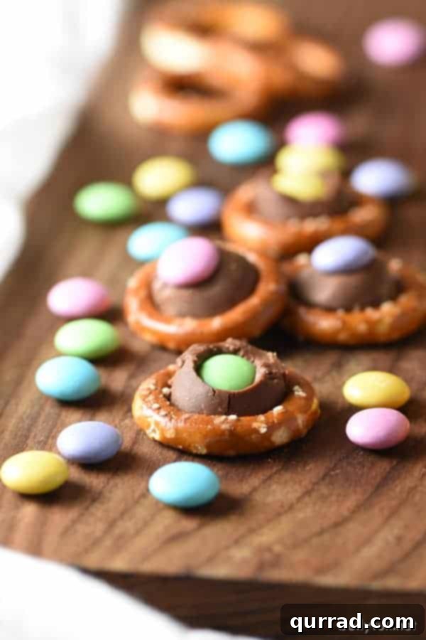 Effortless Easter and Spring Delights 9 Easy sweet and salty Easter Pretzel Rings with round pretzels, Hershey's kisses, and pastel M&Ms for spring flair.