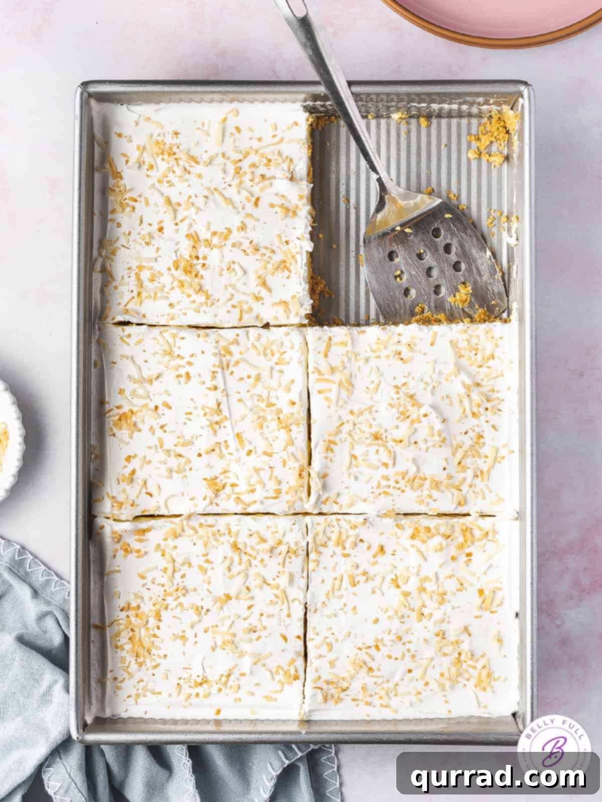 Pineapple Paradise Lush 3 An overhead shot of a chilled pineapple lush dessert, neatly cut into perfect squares, ready to be served.