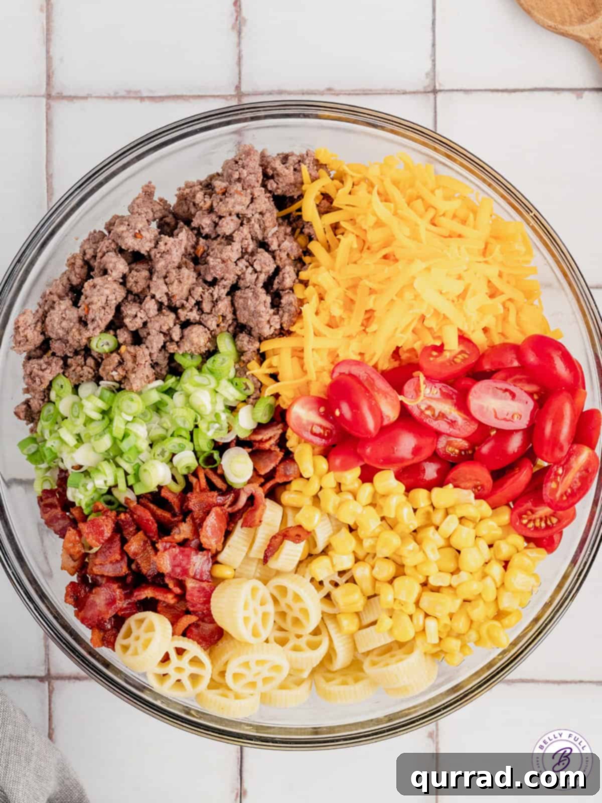 Chuckwagon Pasta Salad 8 Overhead glass bowl with pasta, bacon, ground beef, corn, and cherry tomatoes.