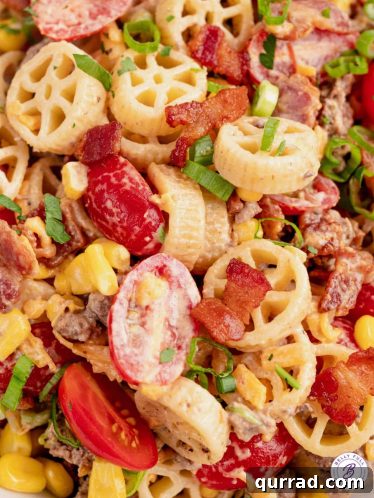 Chuckwagon Pasta Salad 9 Close up creamy wagon wheel pasta salad with bacon and cherry tomatoes.
