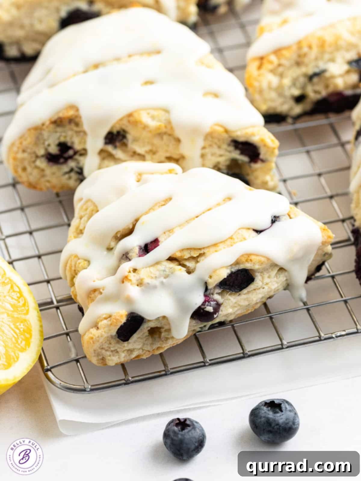 Zesty Lemon Blueberry Scones 2 close up glazed lemon blueberry scone on cooling rack