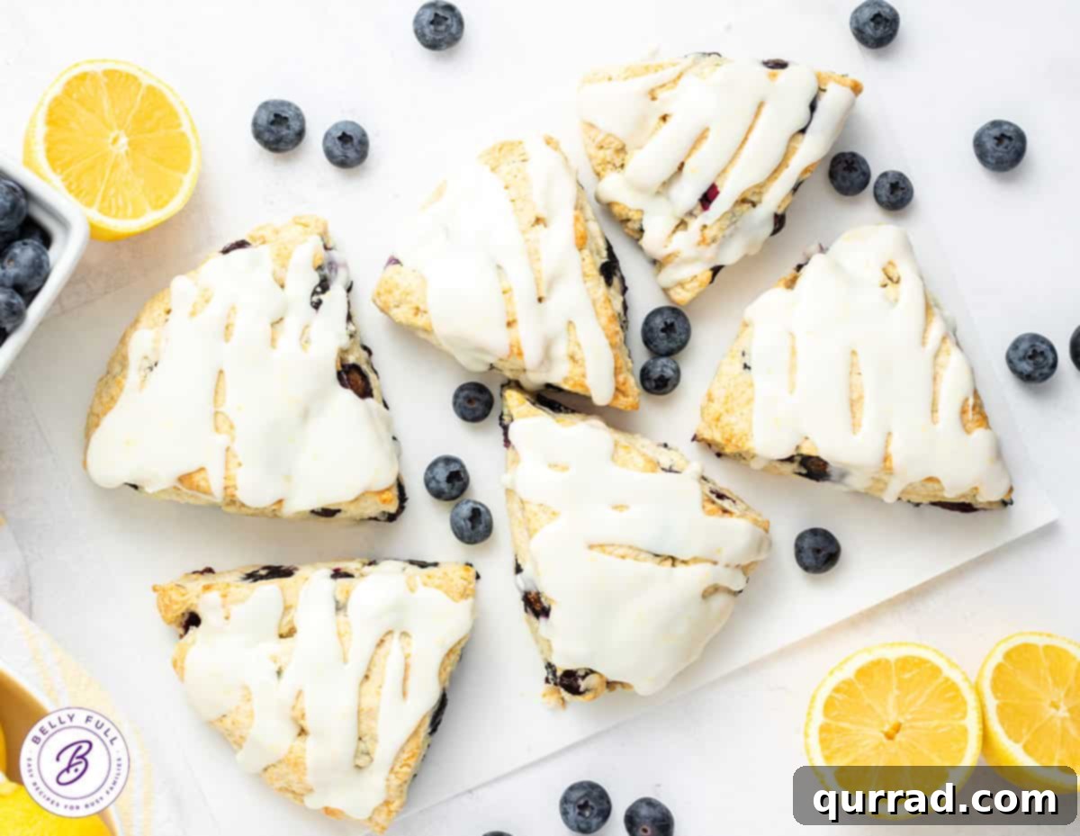 Zesty Lemon Blueberry Scones 4 overhead 6 glazed blueberry scones on white serving tray